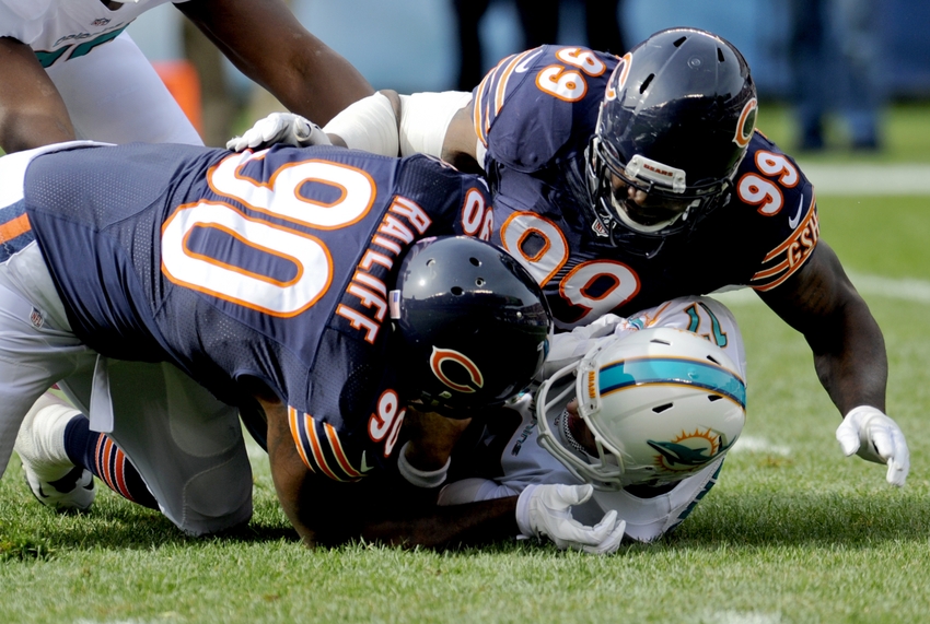 Oct 19, 2014; Chicago, IL, USA; Chicago Bears defensive tackle Jeremiah Ratliff (90) and Chicago Bears defensive end Lamarr Houston (99) sack Miami Dolphins quarterback Ryan Tannehill (17) in the first quarter of their game at Soldier Field. Mandatory Credit: Matt Marton-USA TODAY Sports